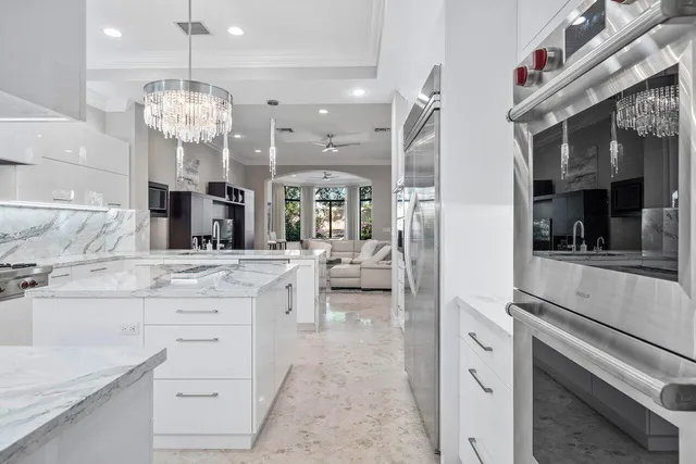 a bedroom with a bed tv on table and a large window