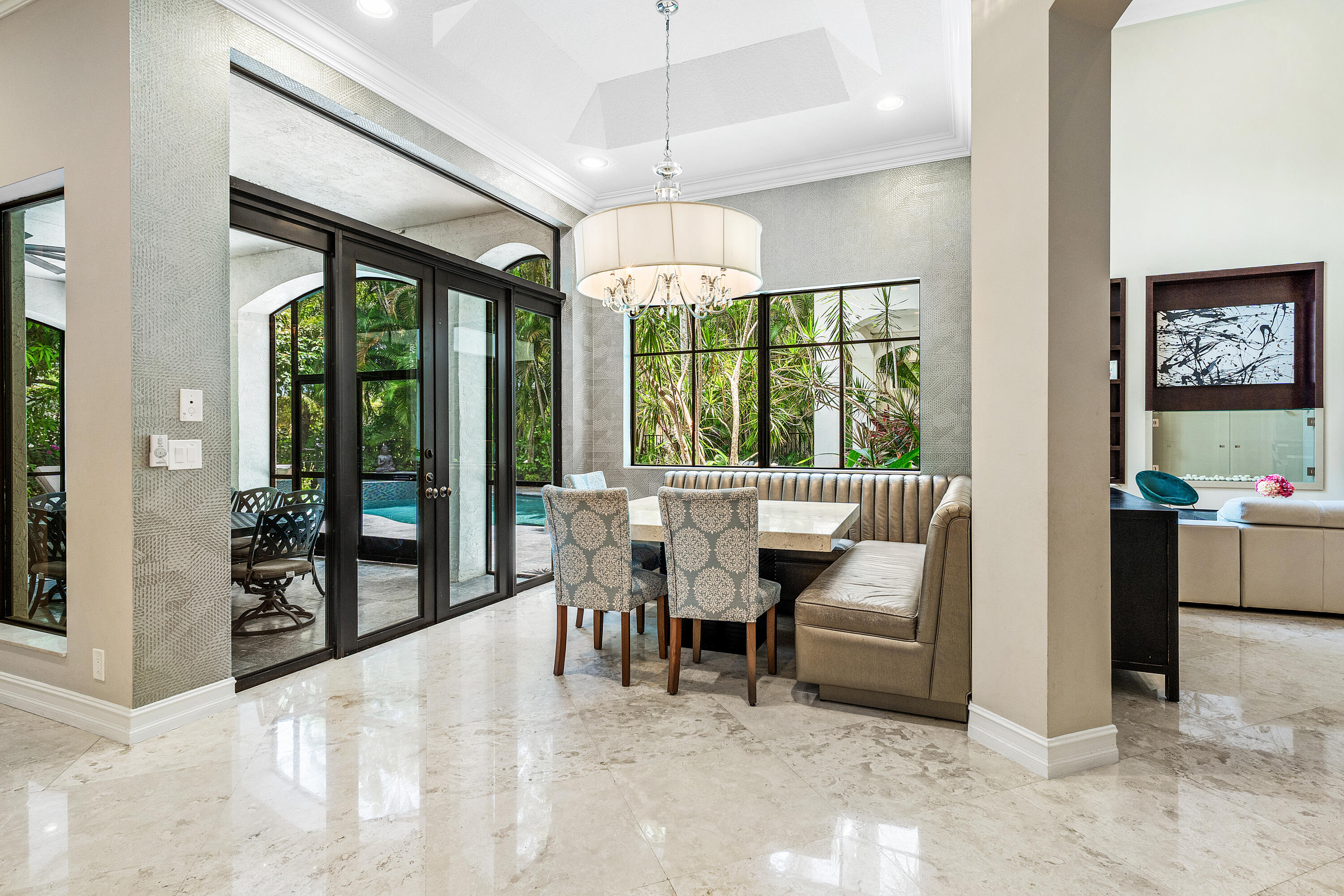17657 Middlebrook Way Boca Raton, FL 33496 - Photo 20 of 98 a dining room with furniture large windows and a chandelier
