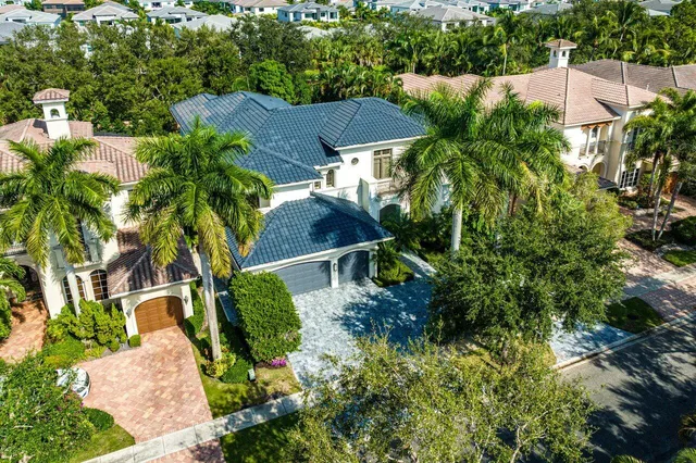 an aerial view of a house with yard and outdoor seating