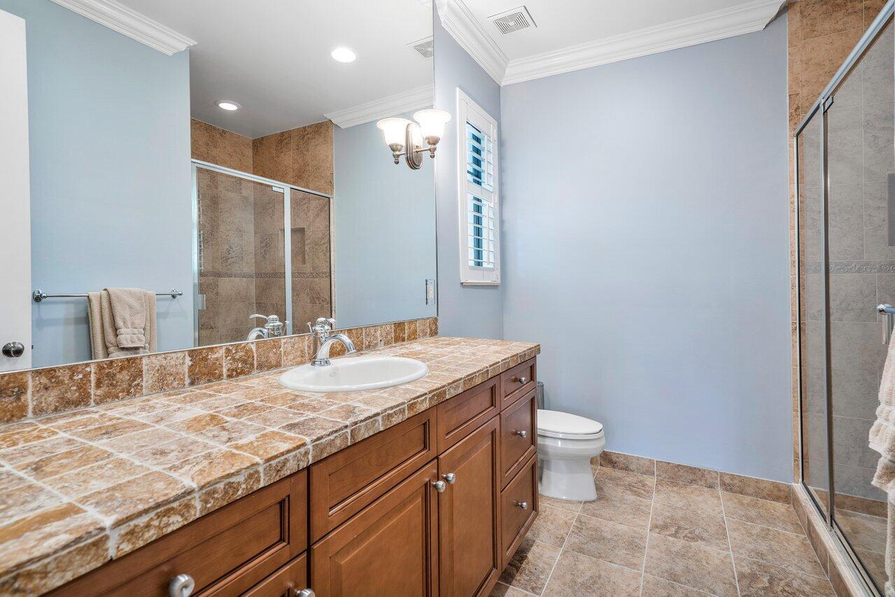 17657 Middlebrook Way Boca Raton, FL 33496 - Photo 42 of 98 a bathroom with a granite countertop sink a toilet and a mirror
