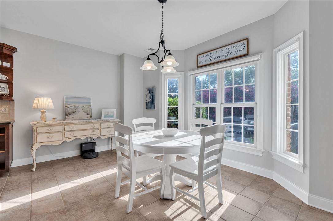 102 Country Walk Lane Clemson, SC 29631 - Photo 8 of 39 Sun-filled dining space with ceramic tile flooring and a classic chandelier, ideal for casual meals.