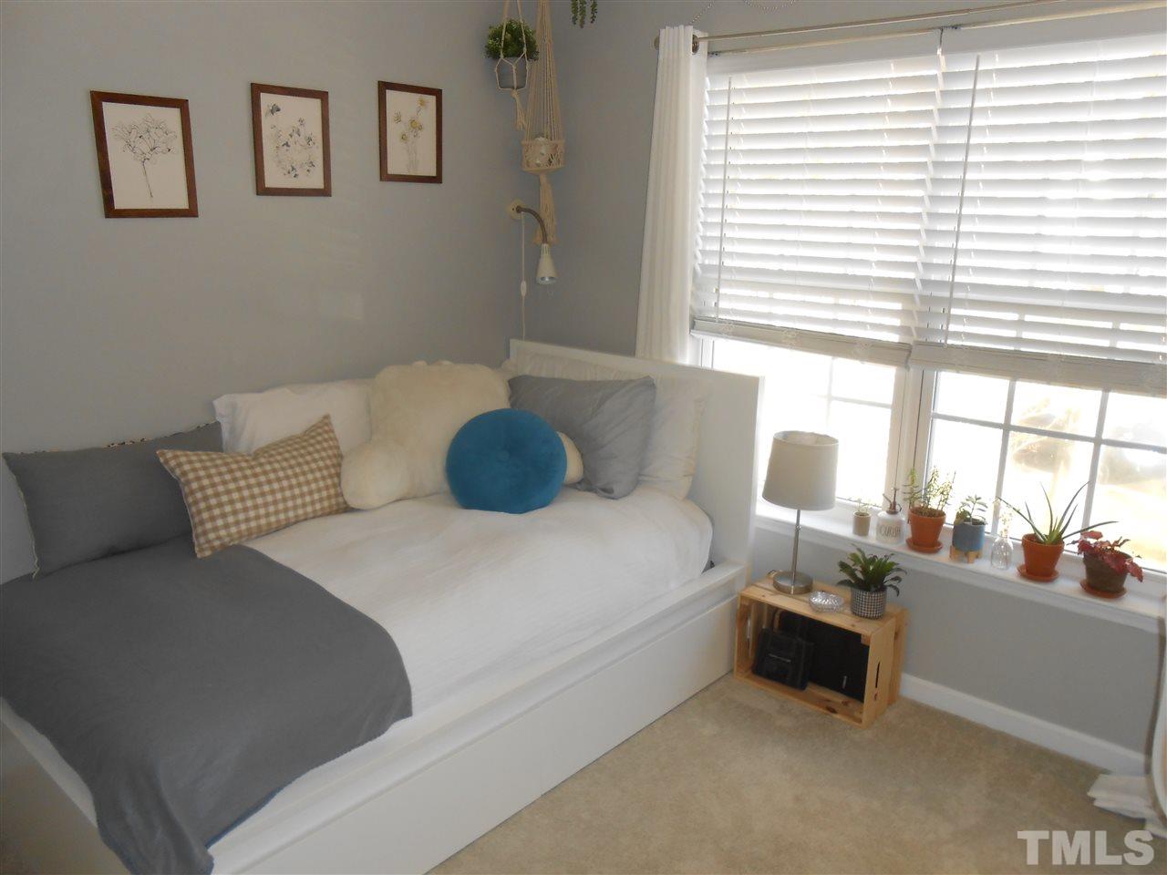 8205 Shadow Stone Court Raleigh, NC 27613 - Photo 22 of 30 a bedroom with a bed and a large window