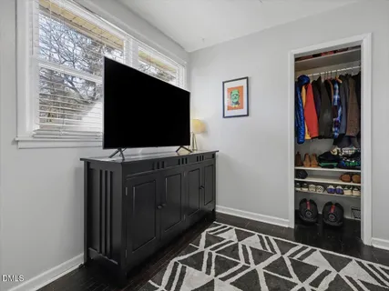 a room with wooden floor and furniture