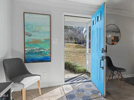a view of a dining room with furniture and a window