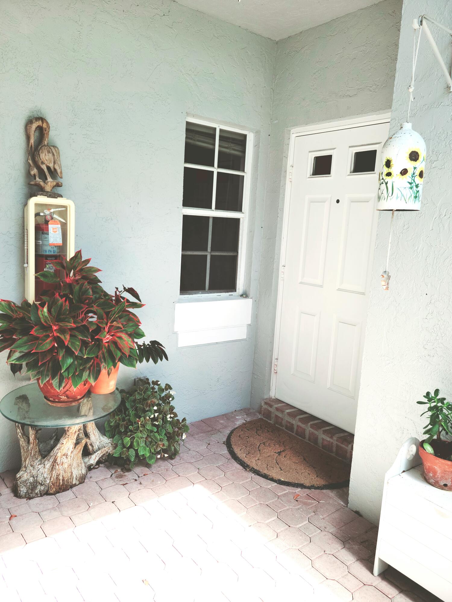 5121 Sabal Gardens Lane, Unit 2 Boca Raton, FL 33487 - Photo 2 of 25 a room with wooden floor and a potted plant
