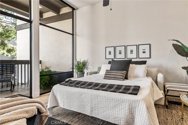 a bed sitting in a bedroom next to a window