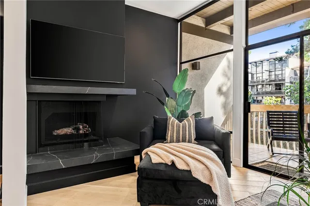 a bedroom with a bed a potted plant and a fireplace
