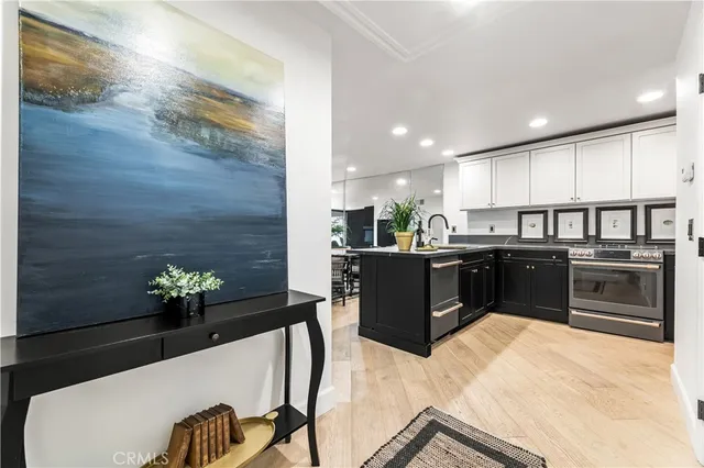 a kitchen with stainless steel appliances kitchen island granite countertop a stove a sink and a refrigerator