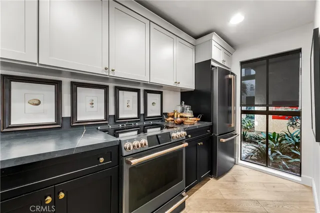 a kitchen with stainless steel appliances granite countertop a stove a refrigerator and a microwave