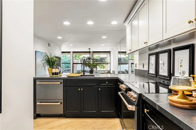a kitchen with granite countertop a sink and appliances