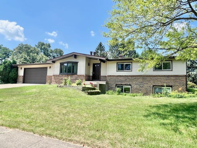 a front view of house with yard and green space