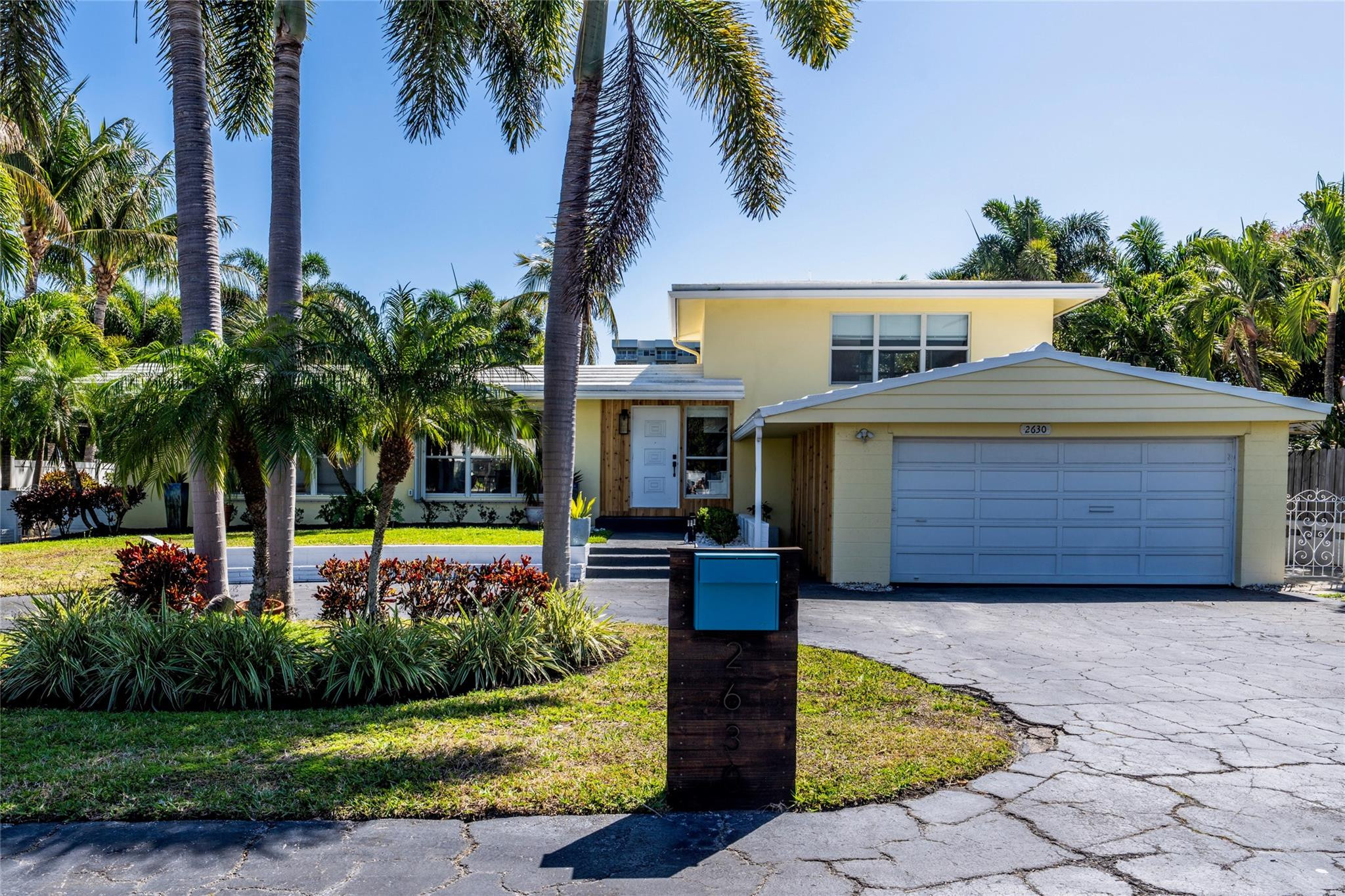 2630 Northeast 25th Street Lighthouse Point, FL 33064 - Photo 3 of 37 a front view of a house with garden