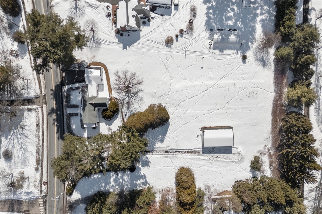 87 Landham Road Sudbury, MA 01776 - Photo 2 of 16 a backyard of a house with table and chairs and potted plants