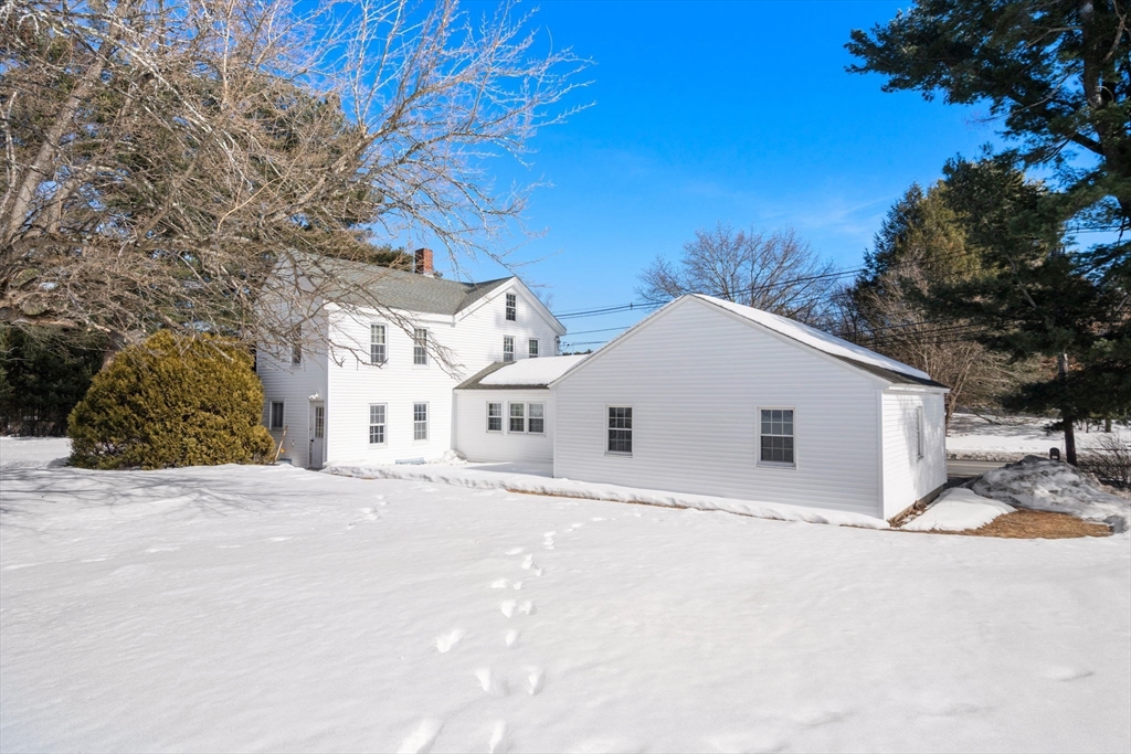 87 Landham Road Sudbury, MA 01776 - Photo 6 of 16 a view of a white house with a yard