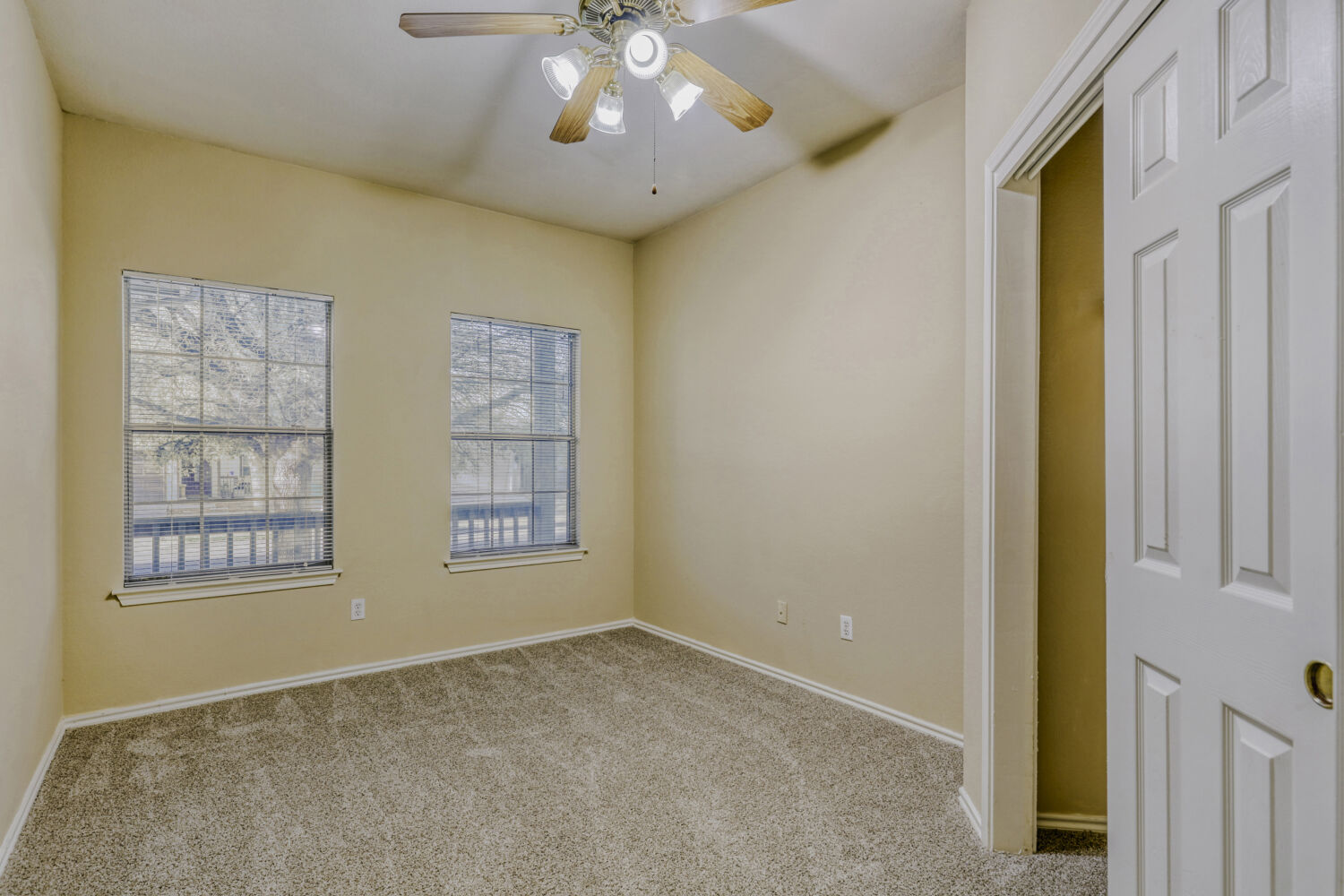 11502 Liberty Street Manor, TX 78653 - Photo 11 of 18 an empty room with windows and chandelier fan