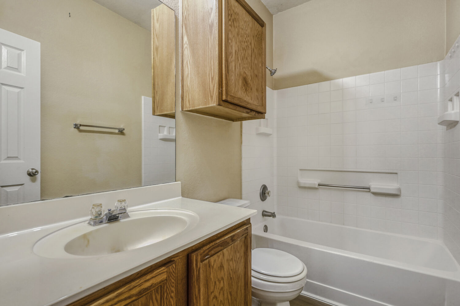 11502 Liberty Street Manor, TX 78653 - Photo 14 of 18 a bathroom with a granite countertop sink toilet and a bathtub