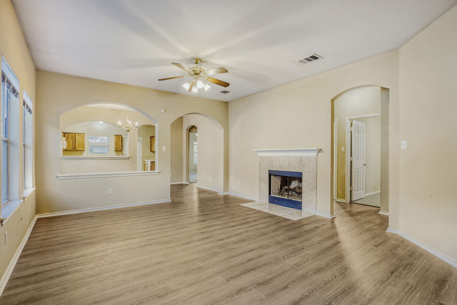 11502 Liberty Street Manor, TX 78653 - Photo 3 of 18 wooden floor fireplace and windows in an empty room