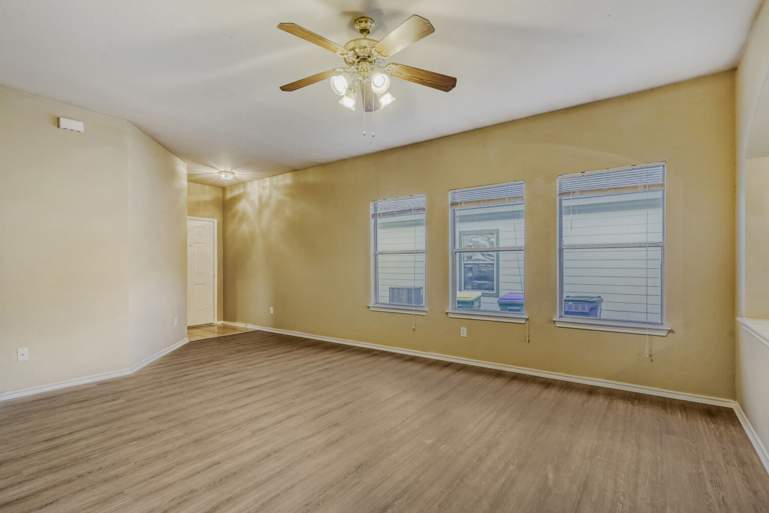 11502 Liberty Street Manor, TX 78653 - Photo 4 of 18 an empty room with wooden floor and windows