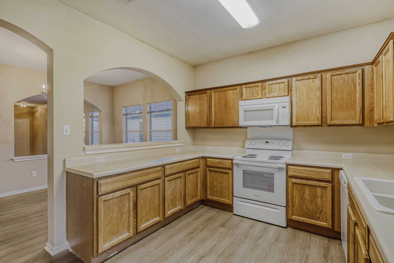 11502 Liberty Street Manor, TX 78653 - Photo 6 of 18 a kitchen with stainless steel appliances granite countertop a stove a sink and a refrigerator