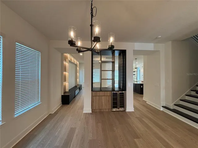 a view of a kitchen with wooden floor and a ceiling fan