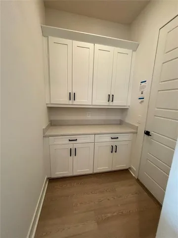 a kitchen with white cabinets and white appliances