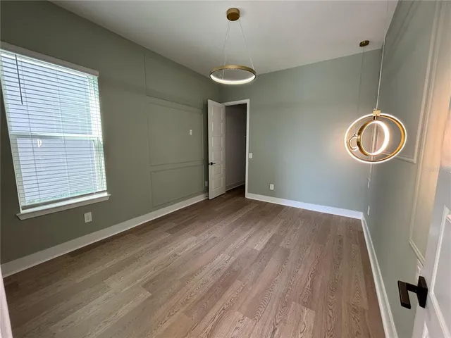 a view of a room with wooden floor and window