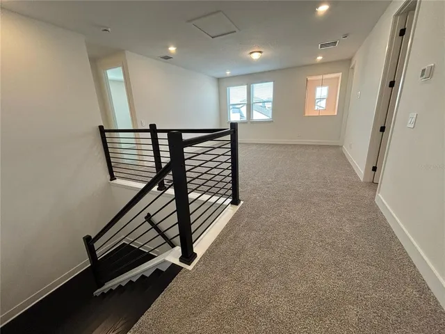 wooden floor in an empty room with windows