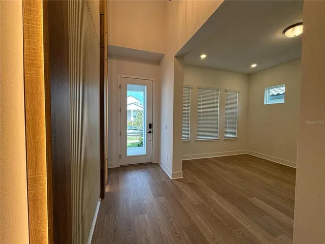 a view of hallway with wooden floor