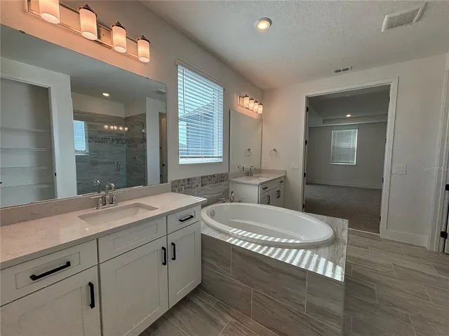 a bathroom with a sink mirror and window