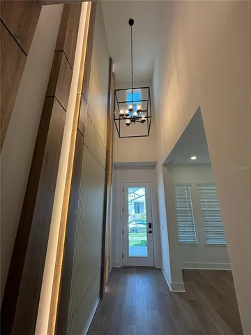 a view of a livingroom with wooden floor and stairs