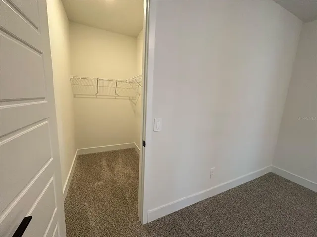 an empty room that has a grey walls