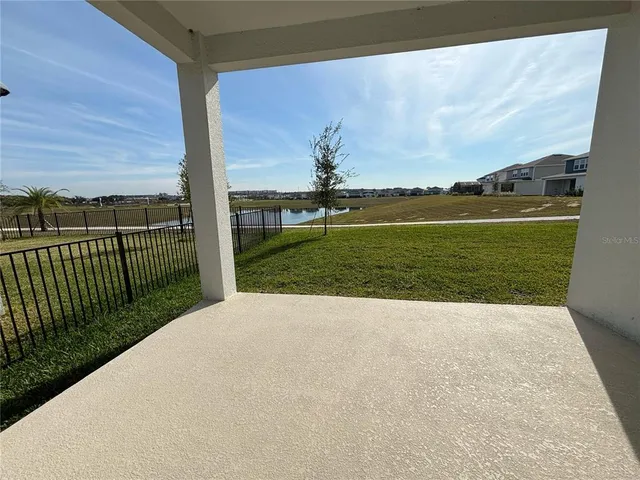a view of empty room with furniture and fan