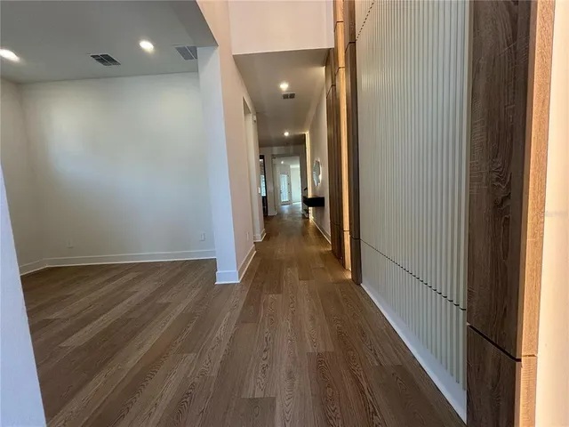 a view of a hallway with wooden floor