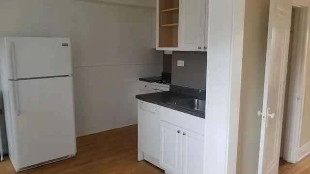 a kitchen with a refrigerator and a stove