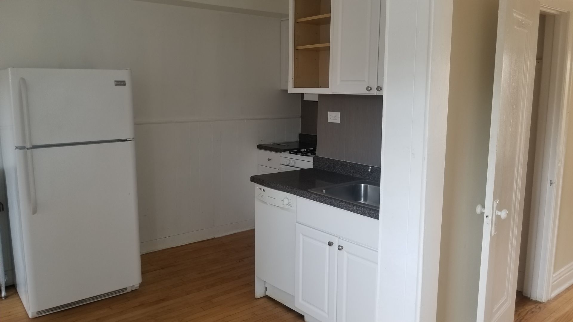 4409 North Kenneth Avenue, Unit 2B Chicago, IL 60630 - Photo 3 of 8 a kitchen with a refrigerator and a stove