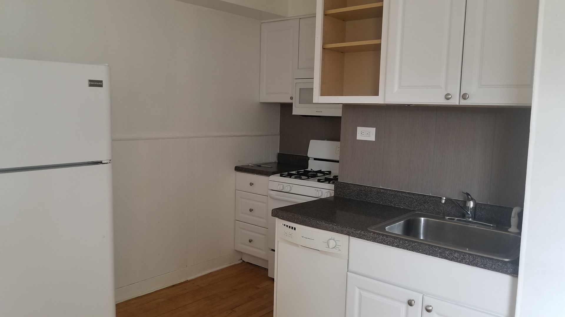 4409 North Kenneth Avenue, Unit 2B Chicago, IL 60630 - Photo 4 of 8 a kitchen with sink cabinets and a stove top oven