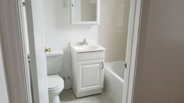 a bathroom with a sink toilet and tub