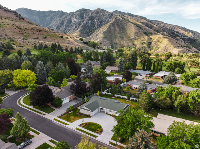 1774 Country Club Drive Logan, UT 84321 - Photo 22 of 28 Street-facing property with a curved driveway, established landscaping, and a manicured lawn