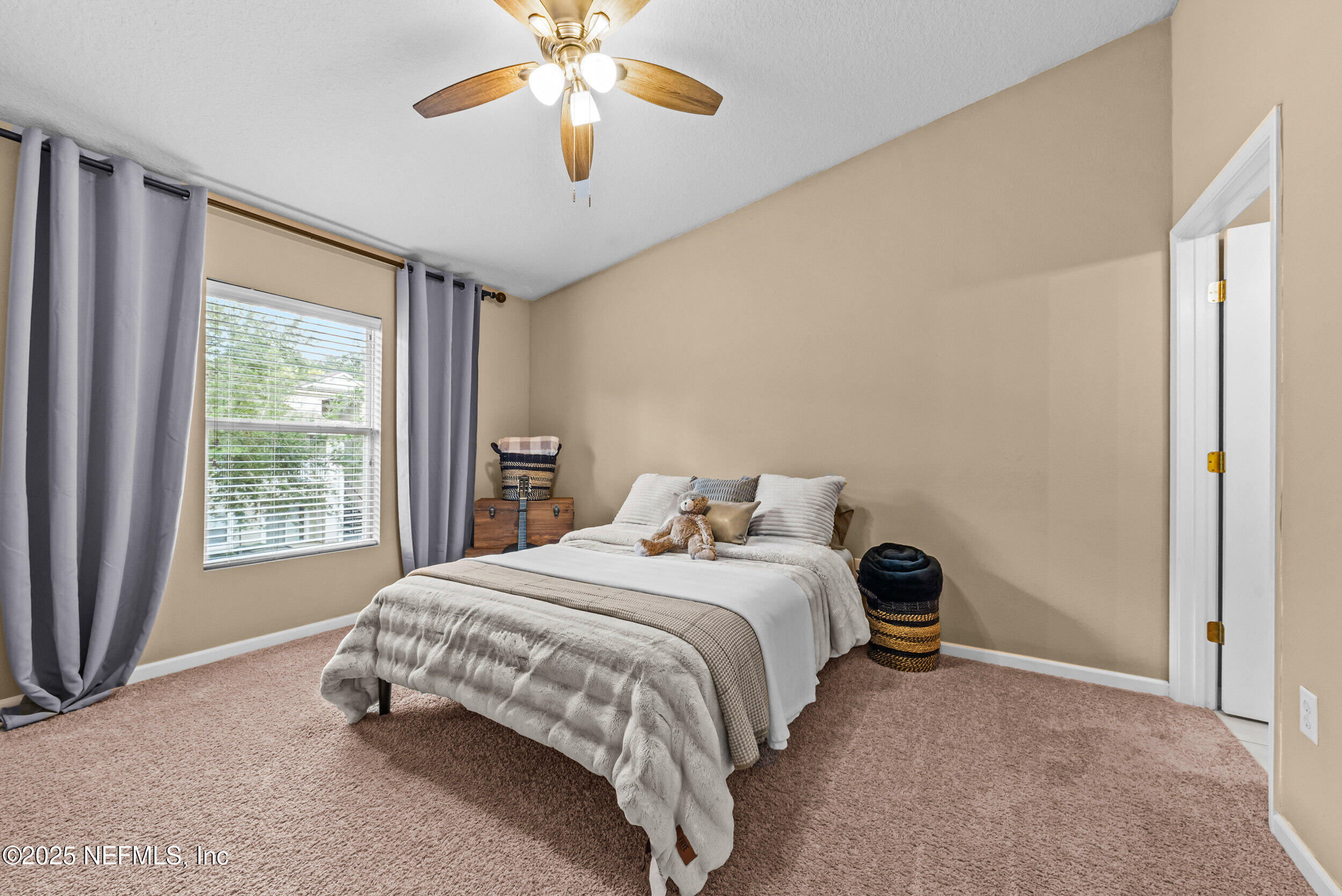 6094 Maggies Circle, Unit 109 Jacksonville, FL 32244 - Photo 14 of 30 a bedroom with a bed and a chandelier