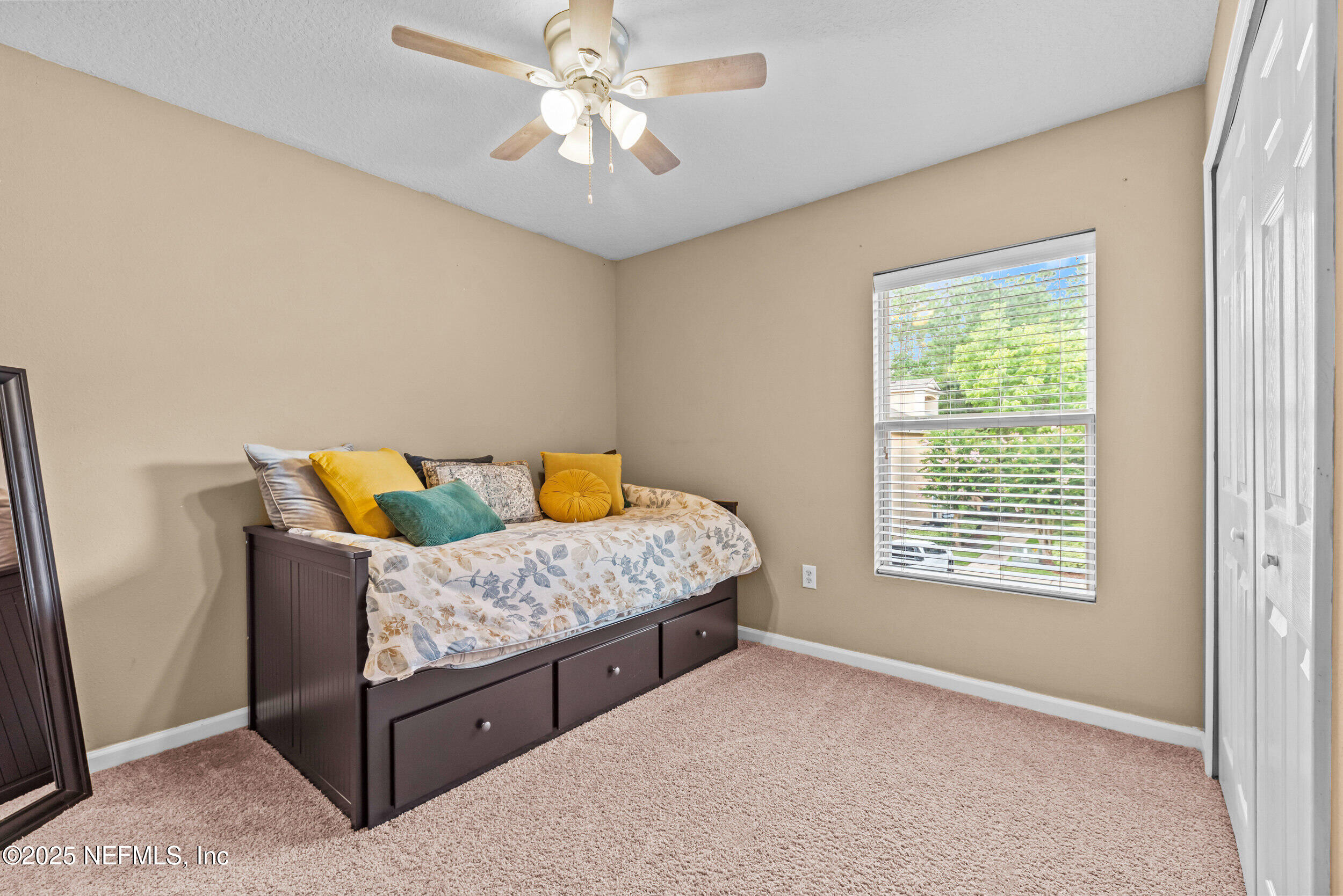 6094 Maggies Circle, Unit 109 Jacksonville, FL 32244 - Photo 17 of 30 a bedroom with a bed and a chandelier