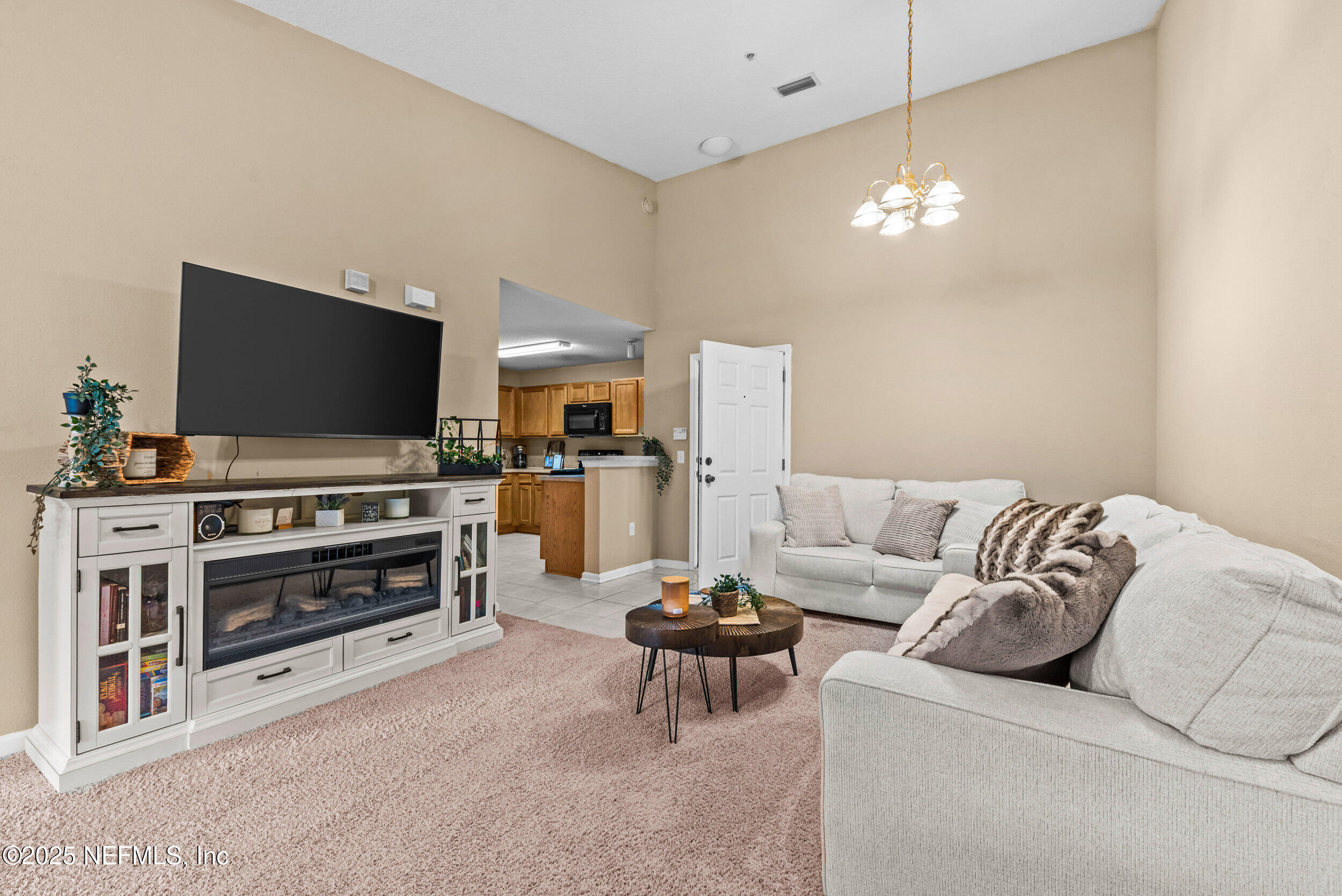 6094 Maggies Circle, Unit 109 Jacksonville, FL 32244 - Photo 6 of 30 a living room with furniture and a flat screen tv