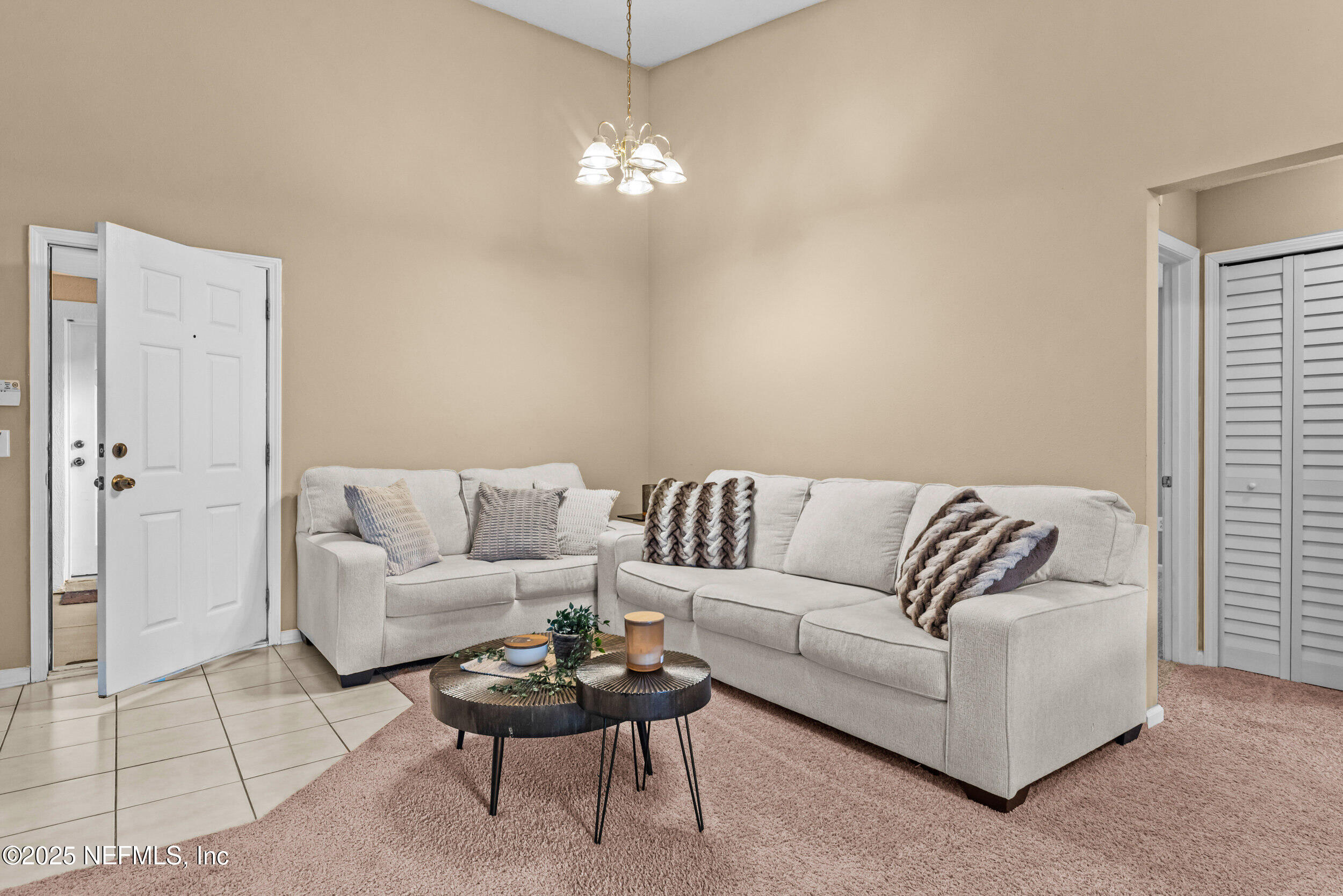 6094 Maggies Circle, Unit 109 Jacksonville, FL 32244 - Photo 9 of 30 a living room with furniture and a chandelier