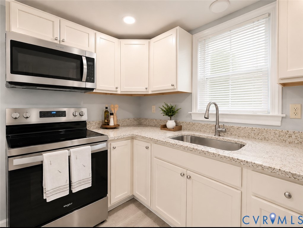 110 Locust Grove Cartersville, VA 23027 - Photo 18 of 26 a kitchen with cabinets appliances a sink and a window