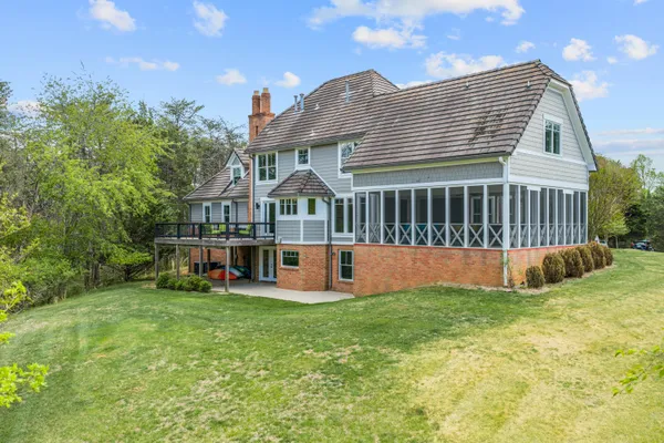 a view of a house with a yard and a garden