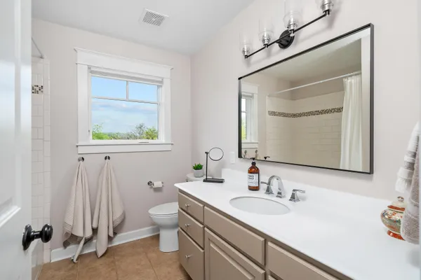 a bathroom with a sink vanity and a toilet