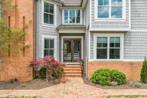 a front view of a brick house with a yard