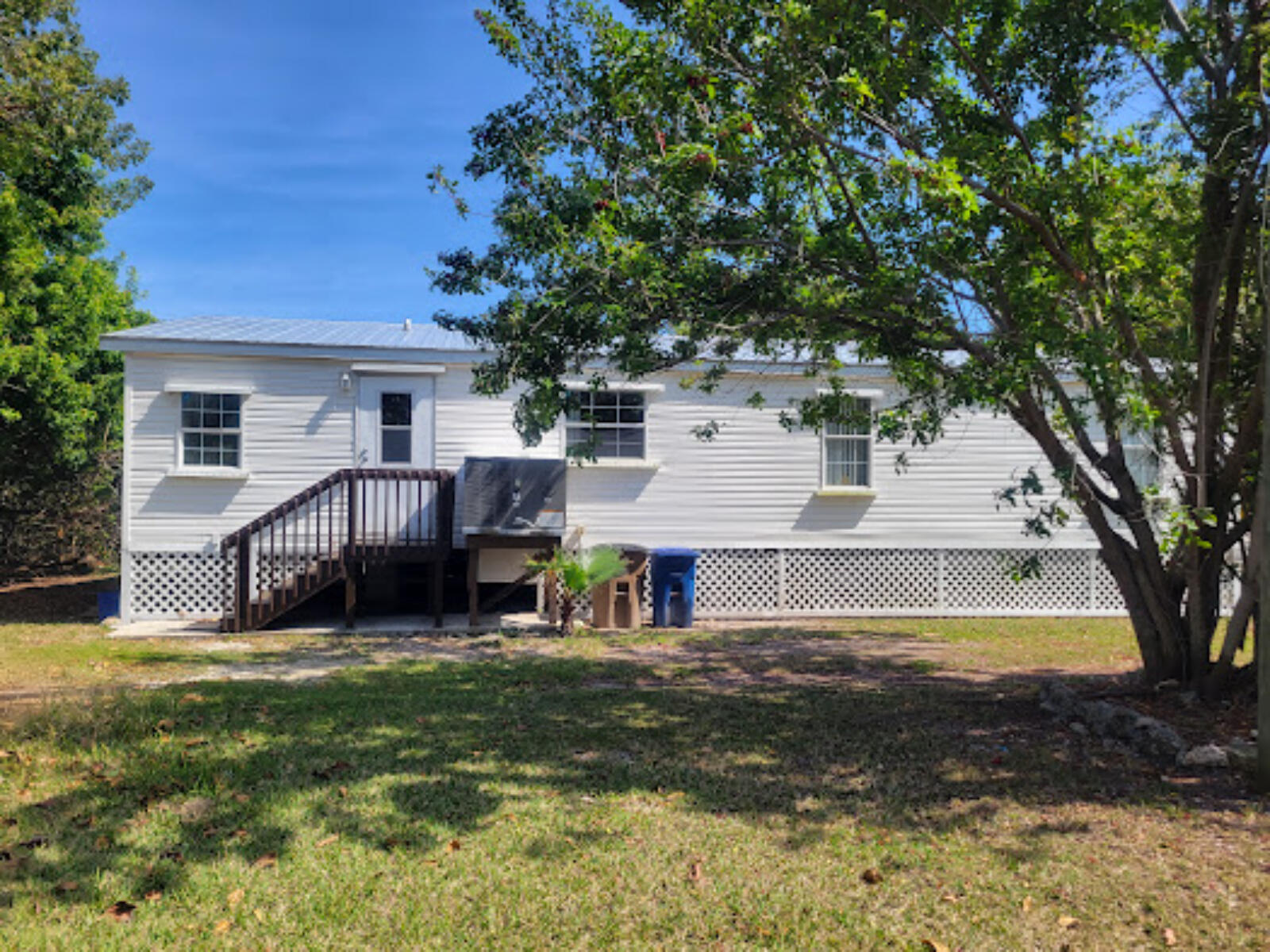 31037 Ave D Big Pine Key, FL 33043 - Photo 16 of 20 a view of a house with a big yard and large tree