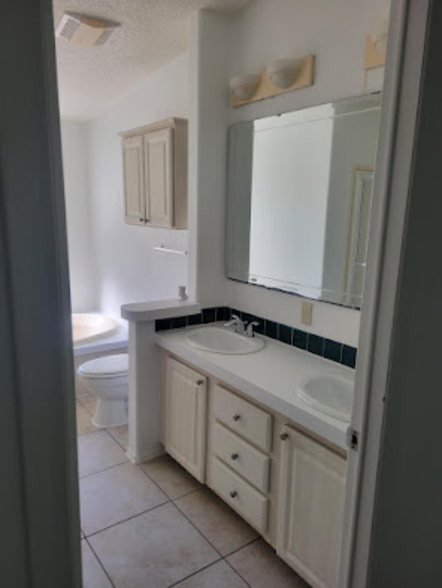 31037 Ave D Big Pine Key, FL 33043 - Photo 19 of 20 a bathroom with a sink and a mirror