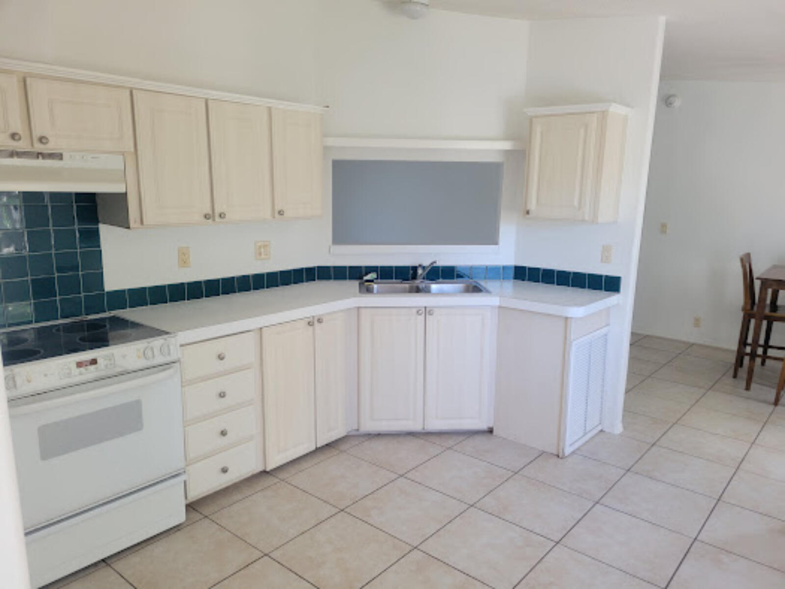 31037 Ave D Big Pine Key, FL 33043 - Photo 7 of 20 a kitchen with granite countertop white cabinets and white appliances