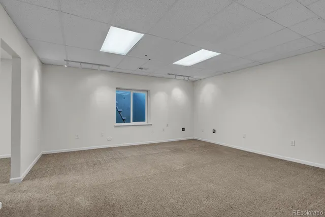 an empty room with a empty space and windows